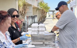 Leadership form Calipatria State Prison prepare food during the Grilling Up Gratitude staff appreciation event.