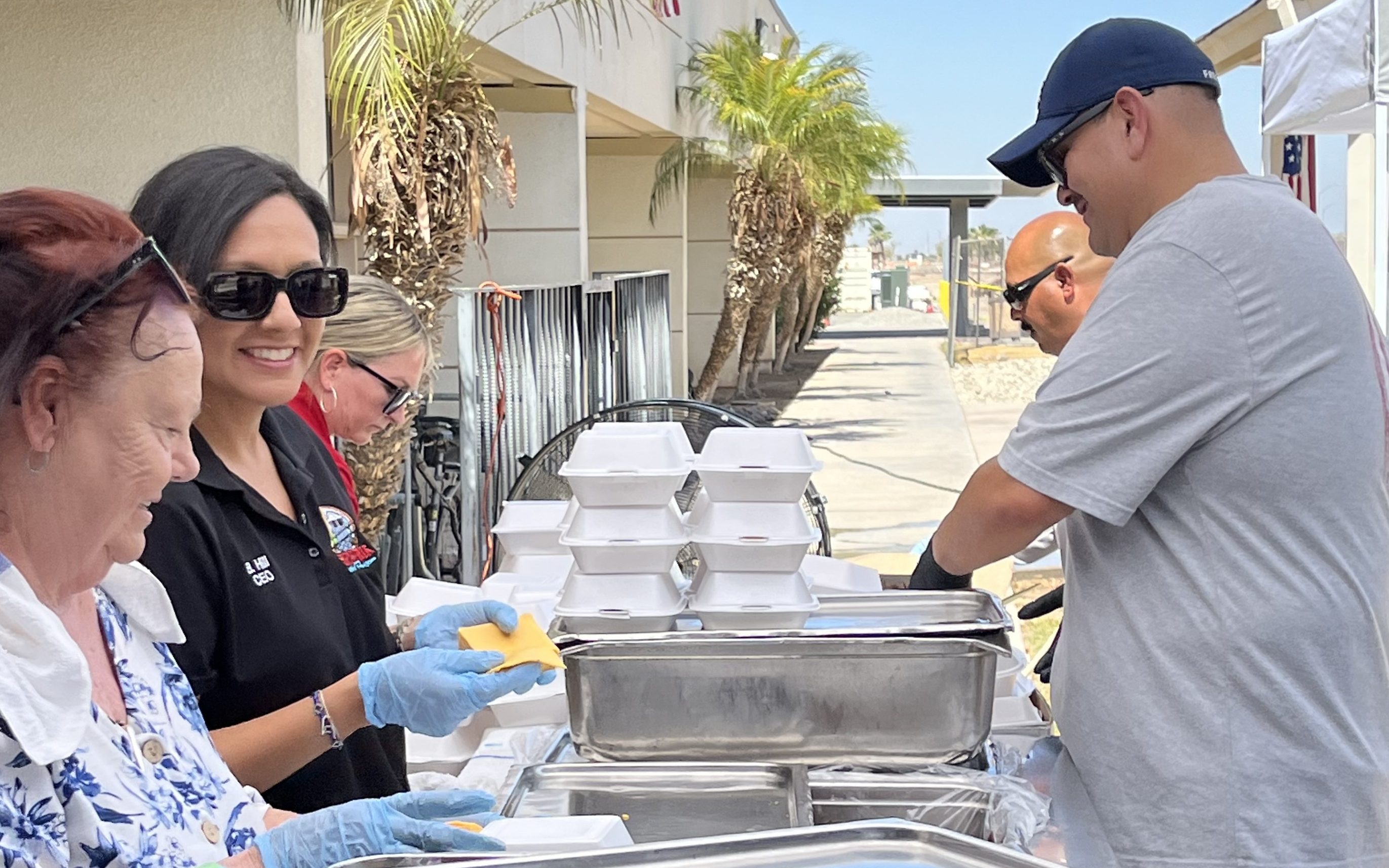 Leadership form Calipatria State Prison prepare food during the Grilling Up Gratitude staff appreciation event.