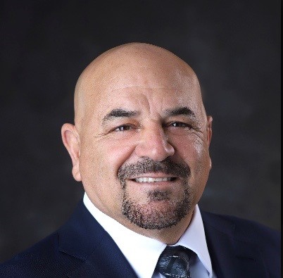 David Tucker wearing a suit and tie.