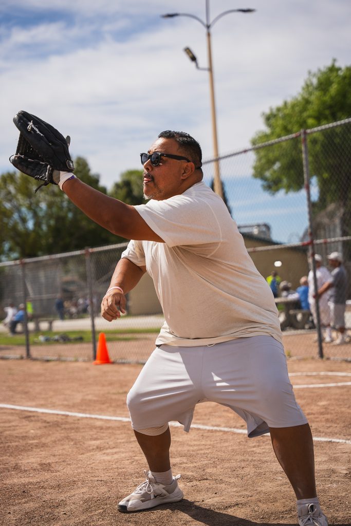 Incarcerated player tries to catch a softball during an exhibition game with the Saints softball team at CIM.