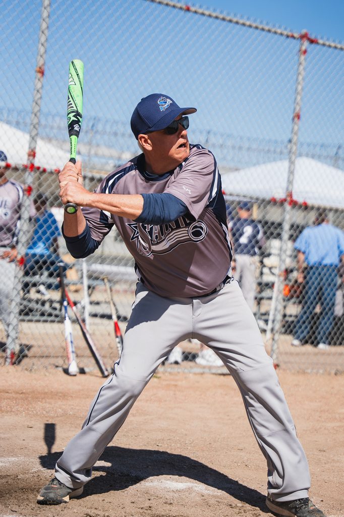Saints softball player at bat at CIM.