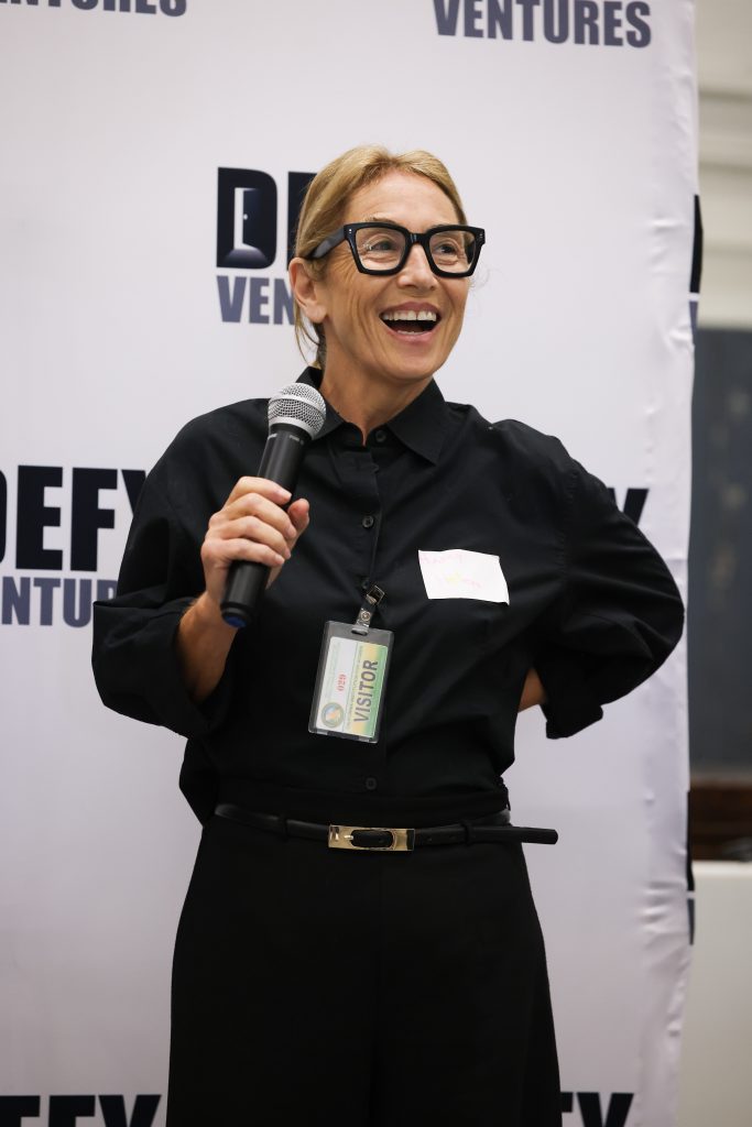 Volunteer for Defy Ventures speaks at the CIW event.