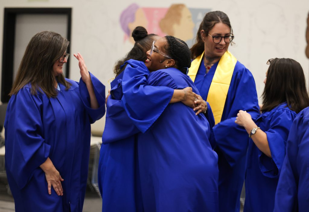 Two people hug after the graduation ceremony at CIW.