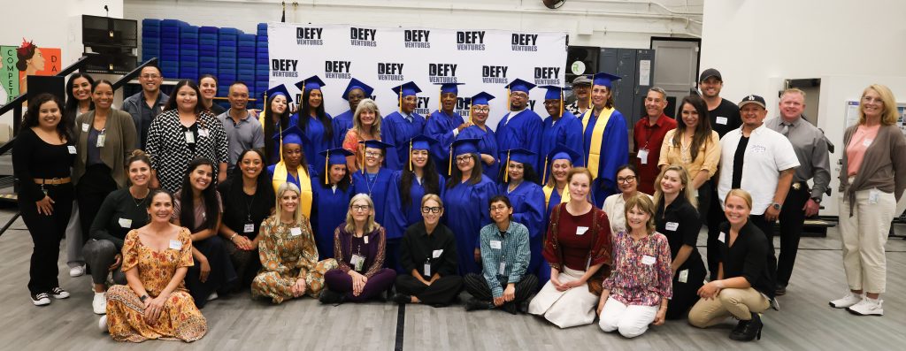 Group photo of community volunteers, Defy Ventures staff and program participants at CIW.