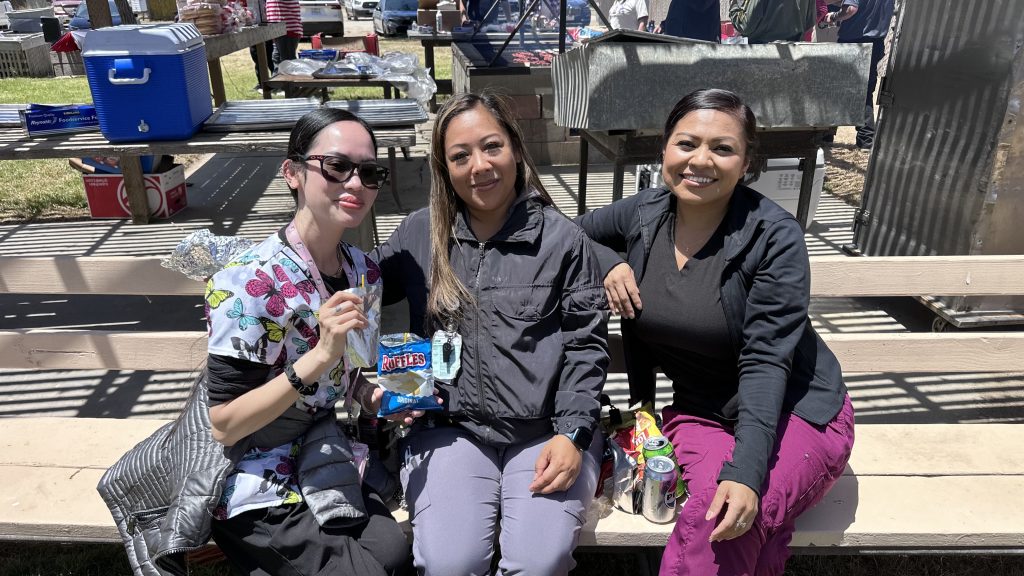 Three female employees sit on a bench at the Staff Appreciation Day at CTF, held July 1, 2026. 
