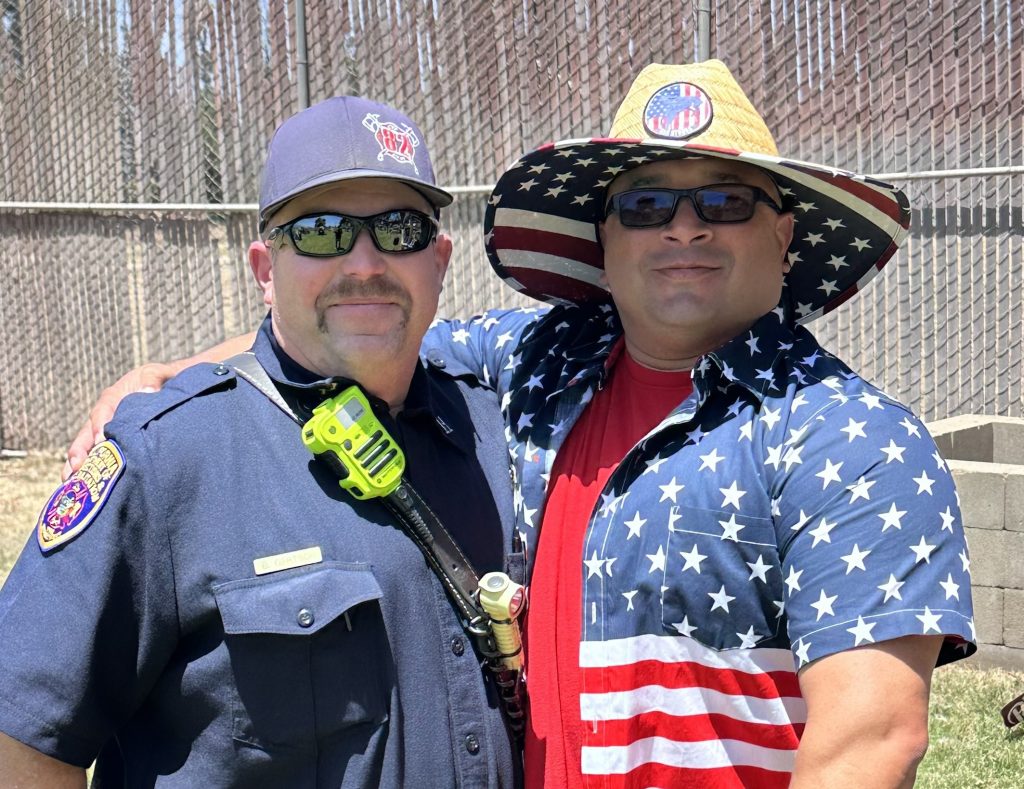 Two staff members at CTF pose for a photo. One is wearing patriotic-themed attire.