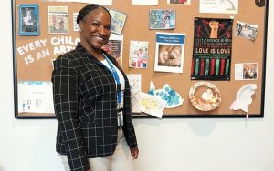 Cassandra Hamm in front of a bulletin board.