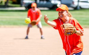 A parole staff member pitches the ball at the DAPO softball tournament benefiting Special Olympics of Northern California.