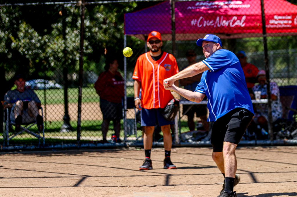 A player takes a swing at a ball during the DAPO softball tournament benefiting Special Olympics Northern California.