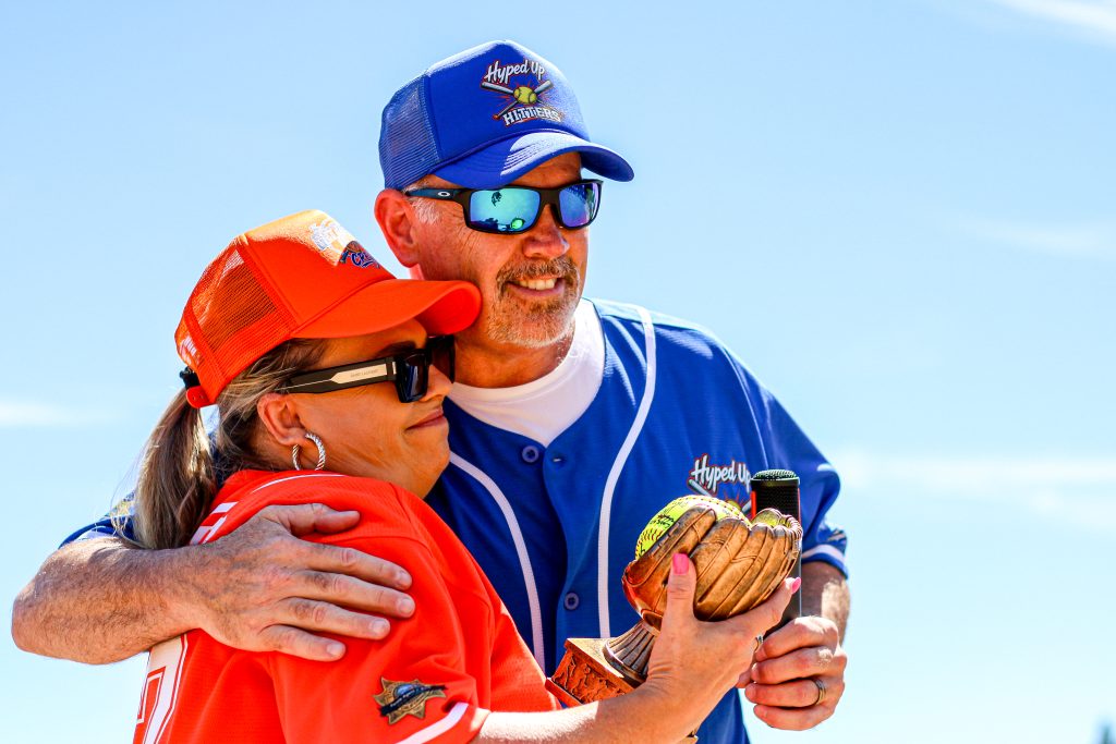 Bryan Bishop, DAPO director, hugs another player. 
