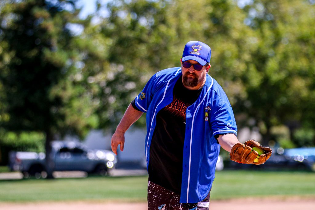 A parole staff member catches a ball during the game.