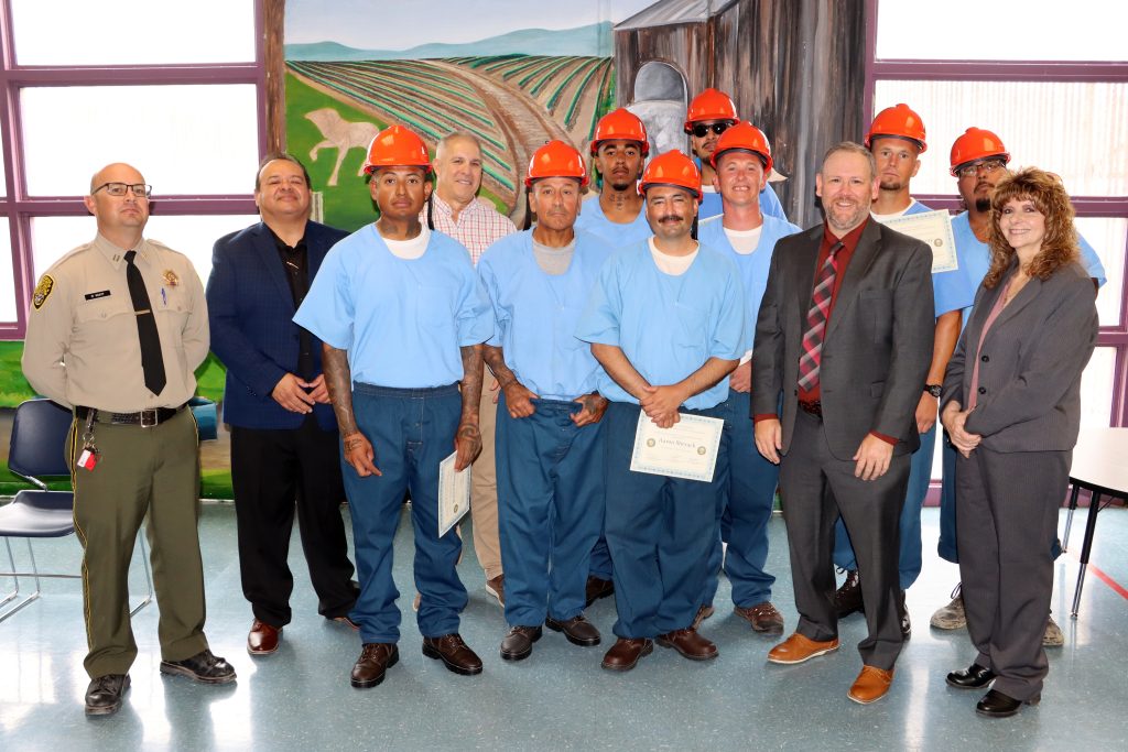 Group photo of staff and incarcerated students earning CCM Pre-Apprenticeship certificates at High Desert State Prison in Susanville, California, July 21, 2026.