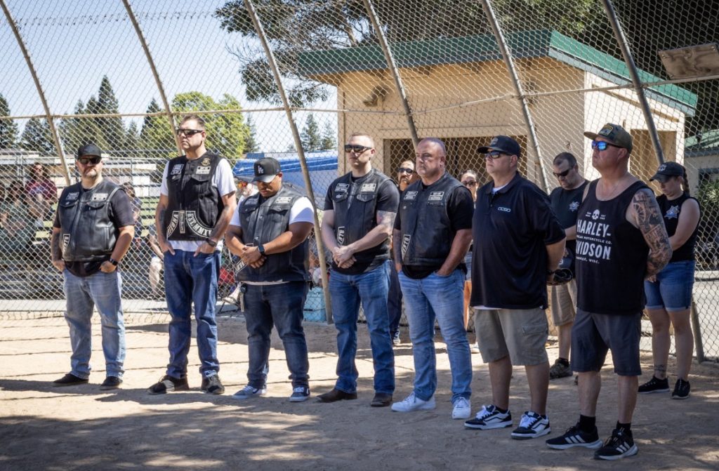 Members of the Shotgun Law Enforcement Motorcycle Club Sacramento Chapter join Correctional Sgt. Tim White of California State Prison, Solano, and K-9 Officer Jimmy Chastain of California State Prison, Solano, as they accept honors on behalf of Correctional Sgt. Jerison Lamb.