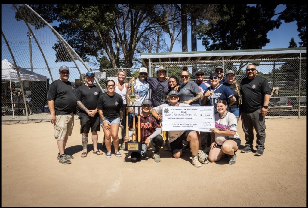 Solano Fallen Resource Fund board members present the championship trophy and prize check to the tournament-winning team from Wasco State Prison.