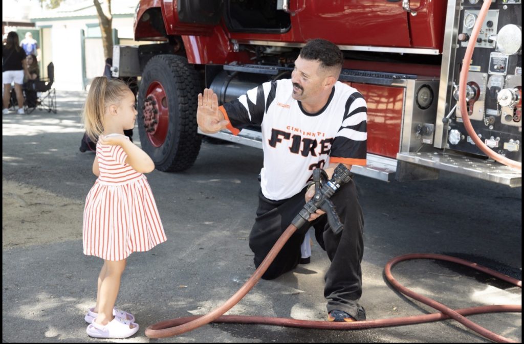 Firefighter Michael Pappa participates in the tournament’s opening ceremony.