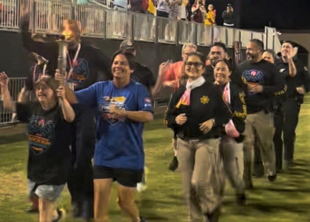 South Bay District staff and participants with torch at Special Olympics Summer Games Opening Ceremony