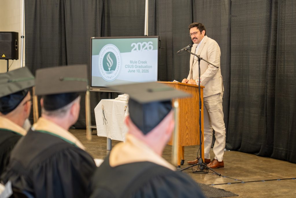 A staff member speaks at the CSU-Sacramento graduation at MCSP.