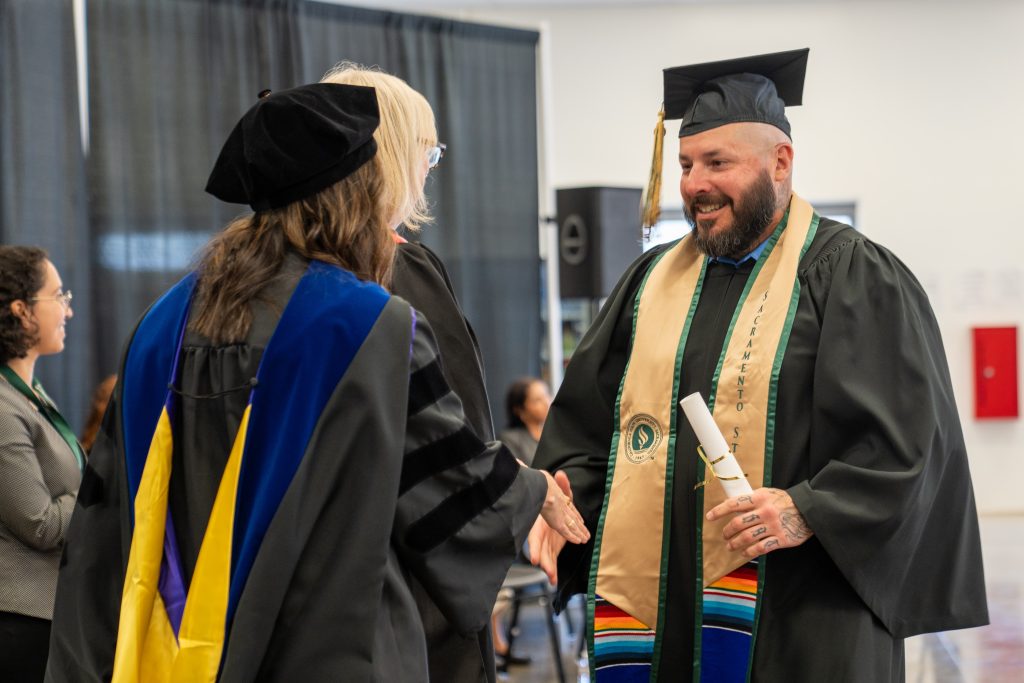 Receiving his degree, an incarcerated person shakes hands with college officials at Mule Creek State Prison in Ione, California.