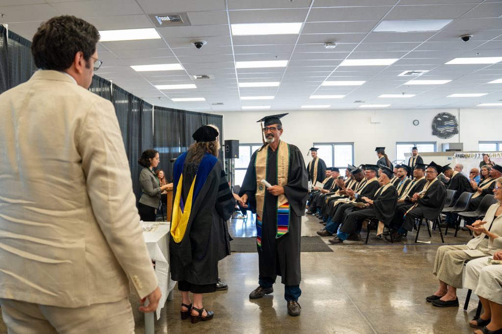 An incarcerated person receives his degree at MCSP in Ione.