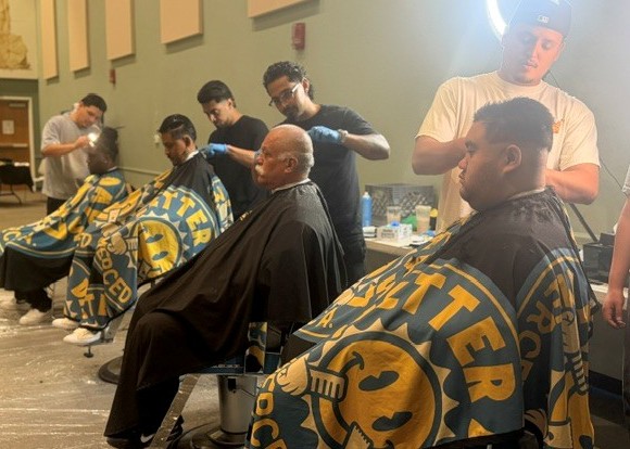 Participants receiving hair services at Merced Community Reentry Resource Fair