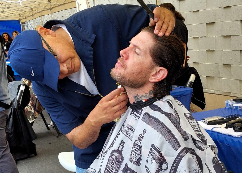 Participant receiving haircut at Father's Day pop up event supporting reentry