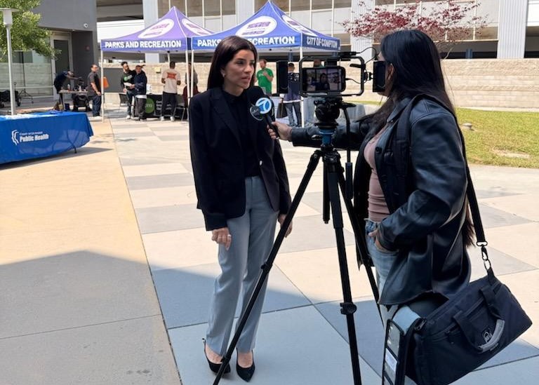 Press conducting interview outside Compton reentry fair