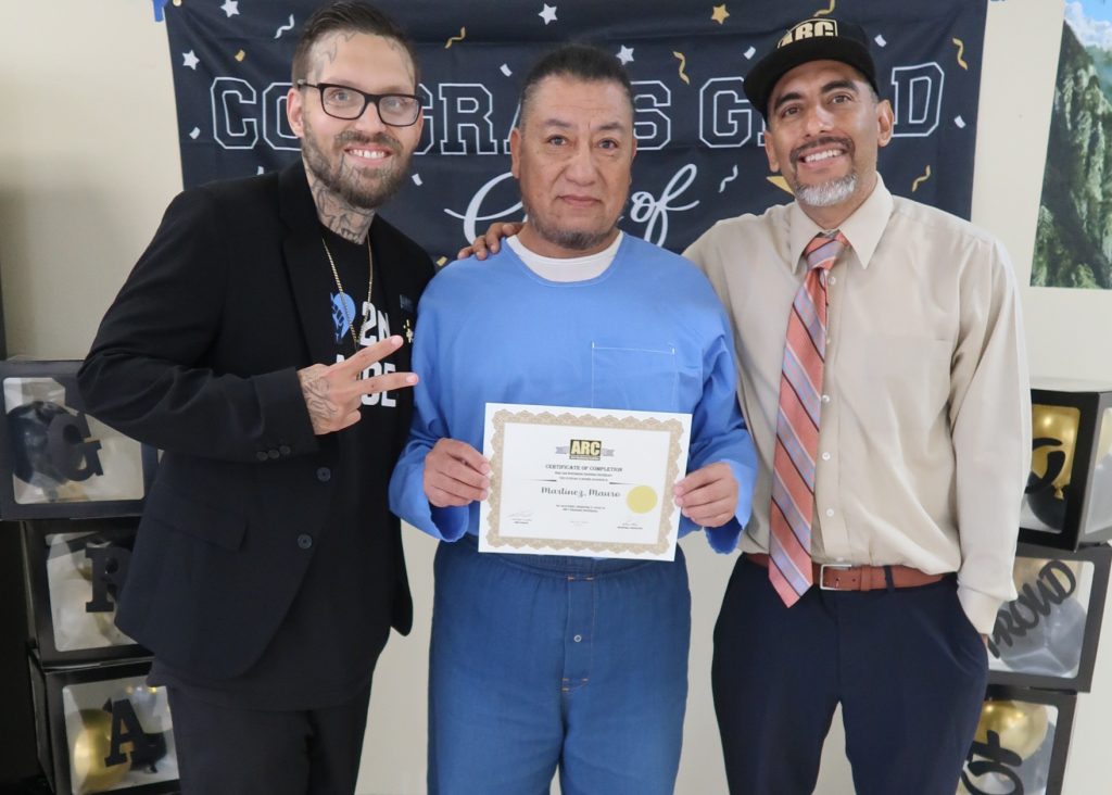ARC graduate with certificate and staff at ASP