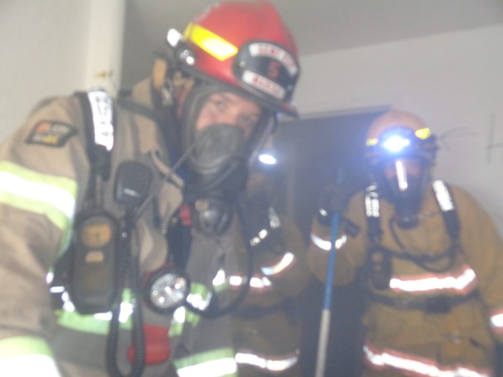 Fire Captain Ries in helmet.
