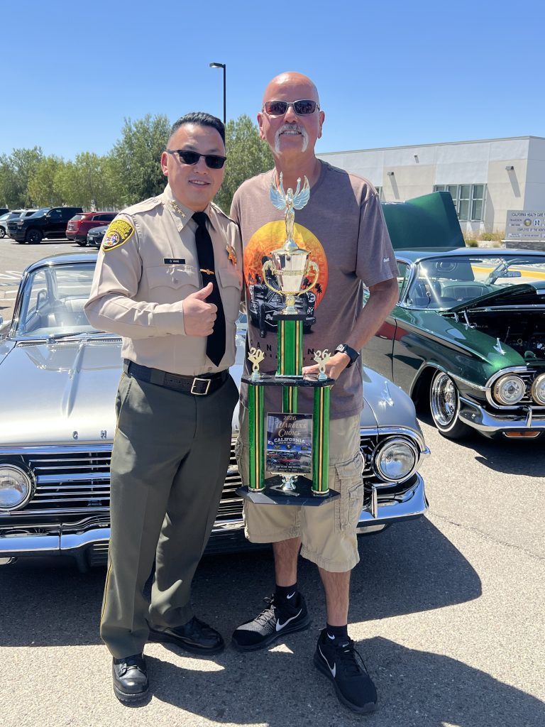 CHCF car show 2026 with Warden Vang presenting a trophy to the grand champion.