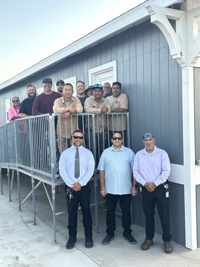 CIM staff with the newly remodeled overnight family visiting modular.