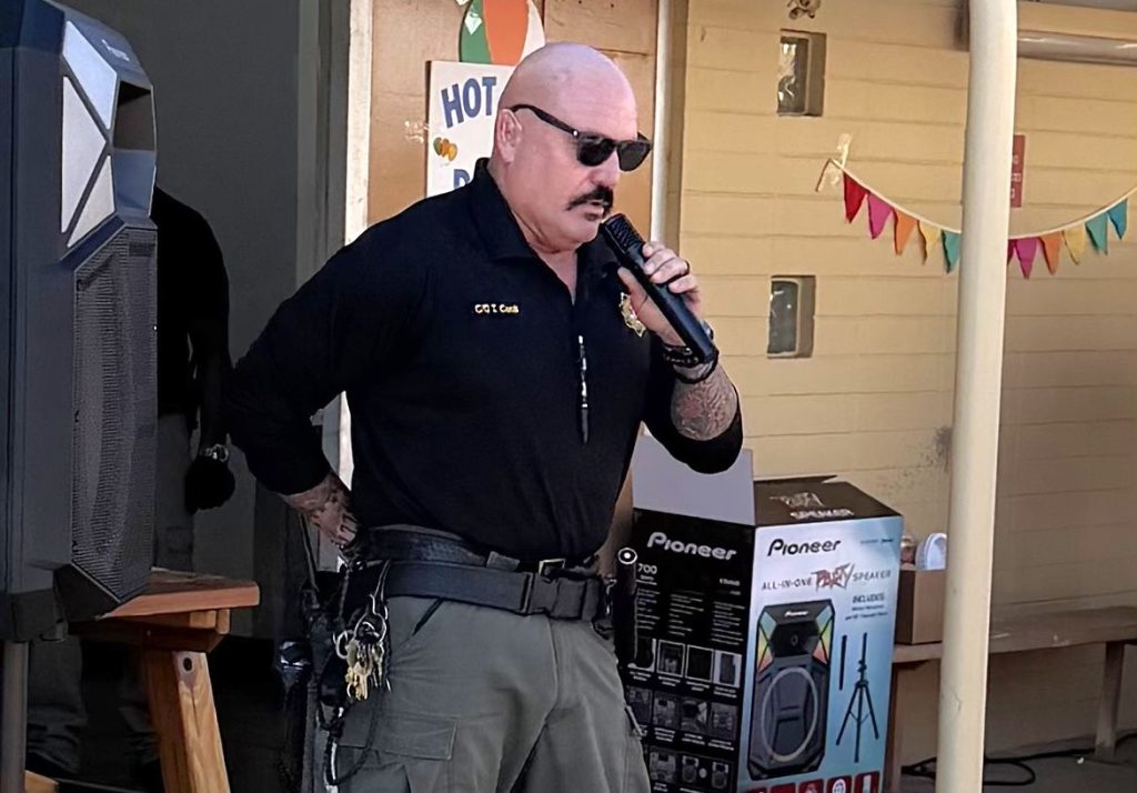 Correctional Officer Terry Cook sings the national anthem.