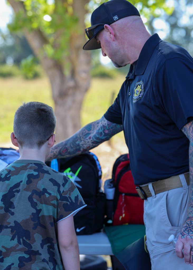 Helping children select a backpack at the CDCR Academy in Galt.