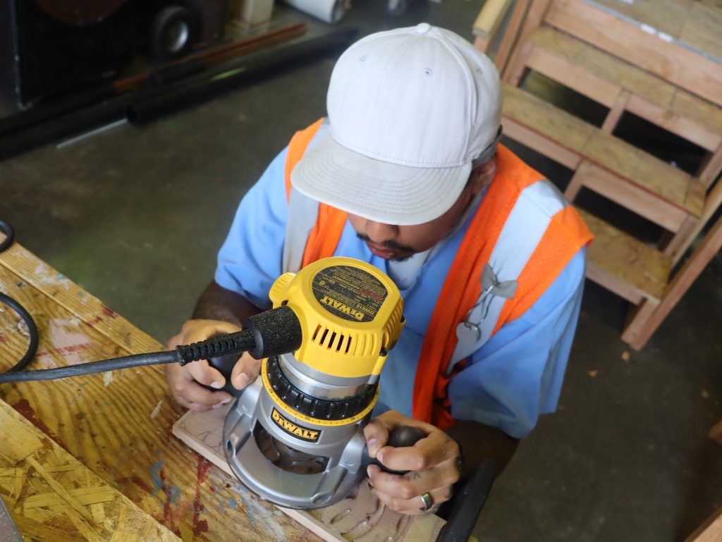 An incarcerated vocational education student uses a router during class at CSP-Solano.
