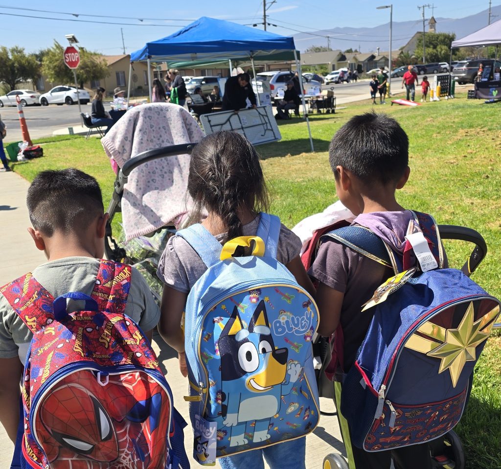 Children wear their new backpacks, donated by CTF-Soledad.