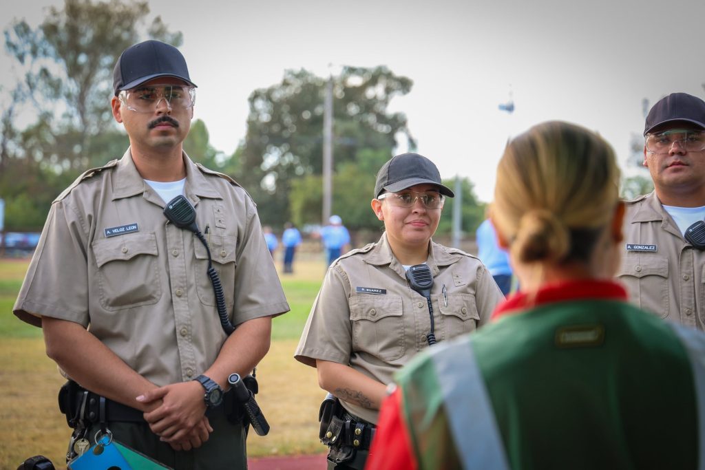 Two cadets listen to an instructor during alarm response training at the CDCR Academy.