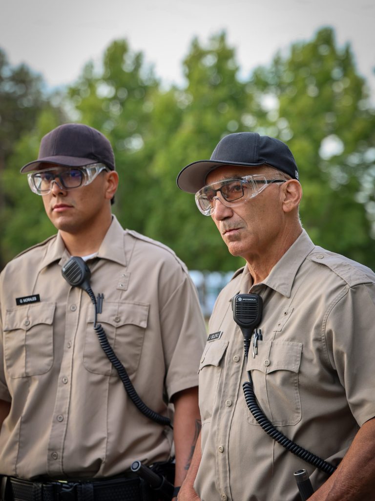 Two cadets listen during instructions for alarm response training at the CDCR Basic Correctional Officer Academy for Class 3-26A.