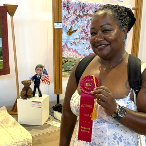 Cooper with award and prize-winning artwork