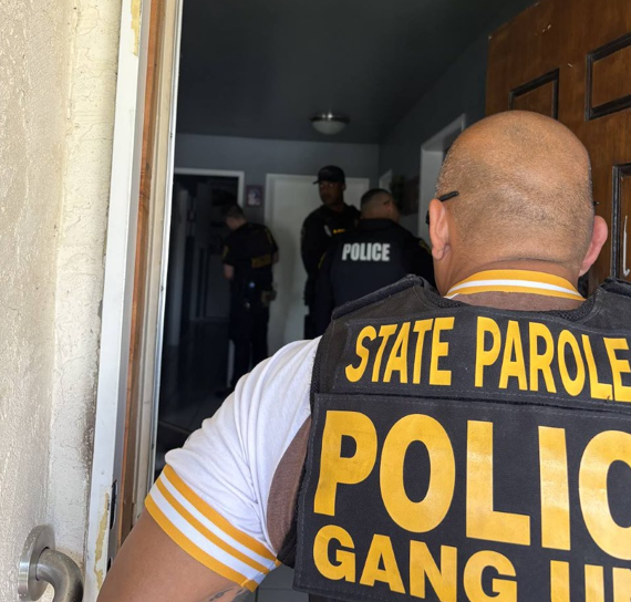 Parole agent enters the home of a supervised person during a compliance check.