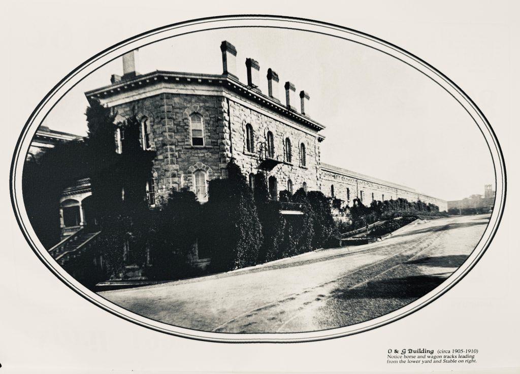 Officers and Guards building at Folsom State Prison, circa 1905-1910. Notice horse and wagon tracks leading from the lower yard and stable on the right.