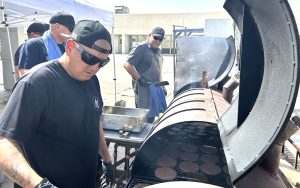 Managers working the grill at the Ironwood State Prison event.