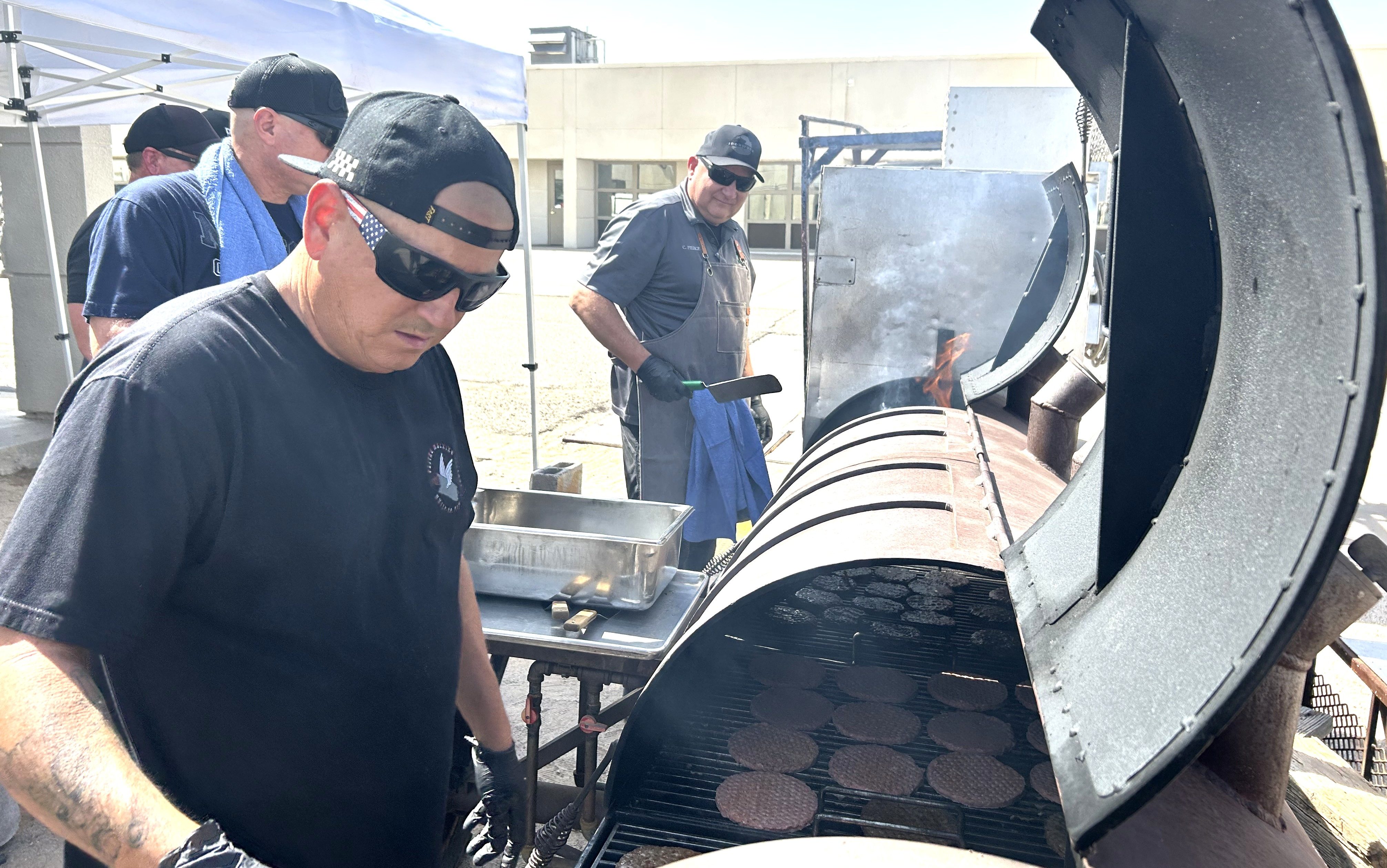 Managers working the grill at the Ironwood State Prison event.