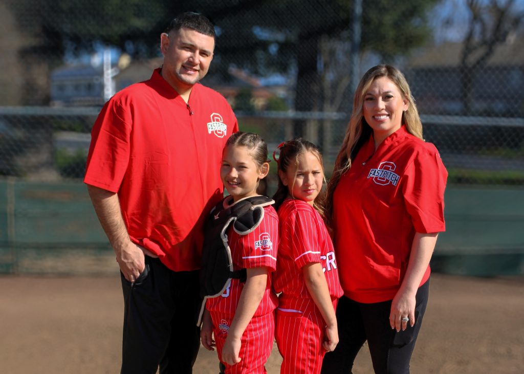 Skylynn and Daniel Murillo with children on softball field