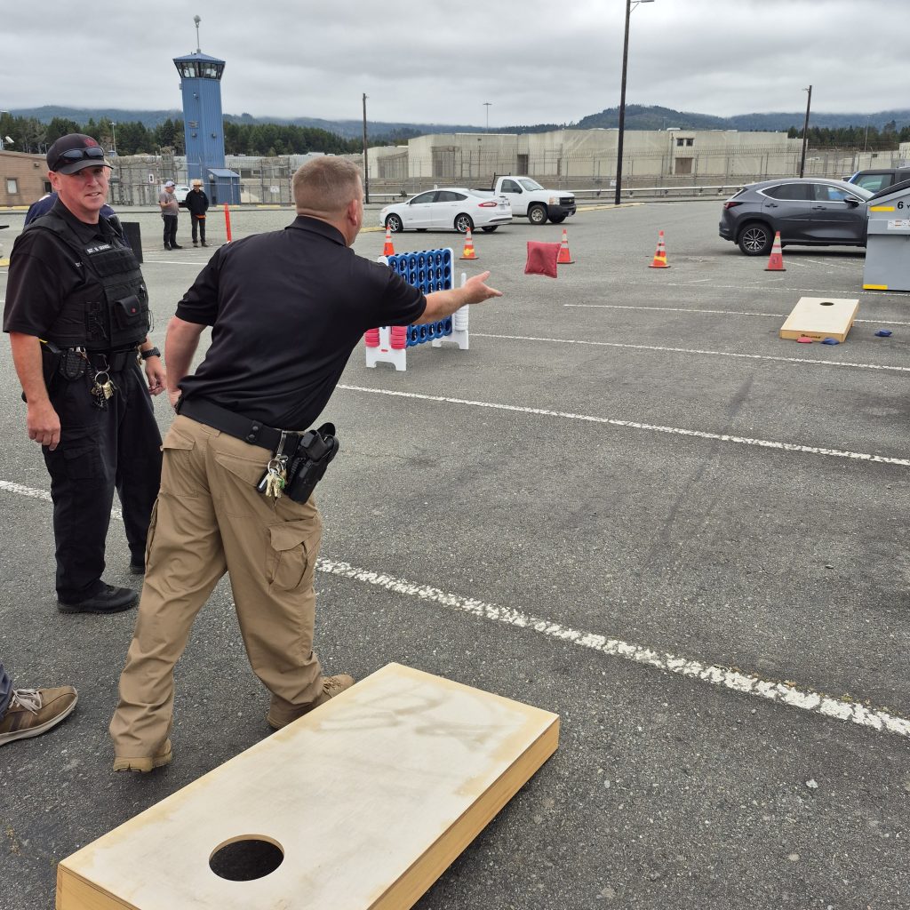 Pelican Bay State Prison staff play a game of bean bag toss during an Employee Appreciation Day.