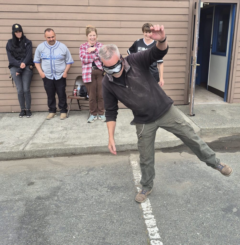 Staff tries to "walk the line" while wearing goggles mimicking the effects of alcohol impairment at Pelican Bay State Prison.