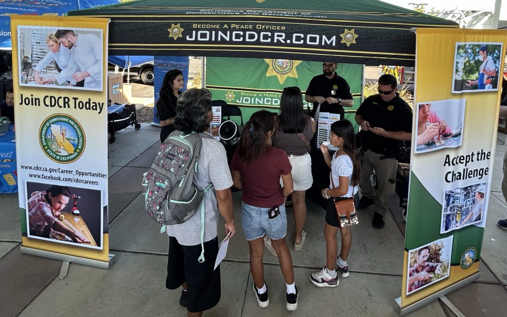 Visitors at the CDCR booth at National Night Out in Natomas.