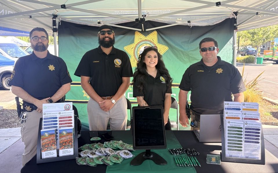Two parole agents with CDCR recruitment unit staff at National Night Out in Natomas.