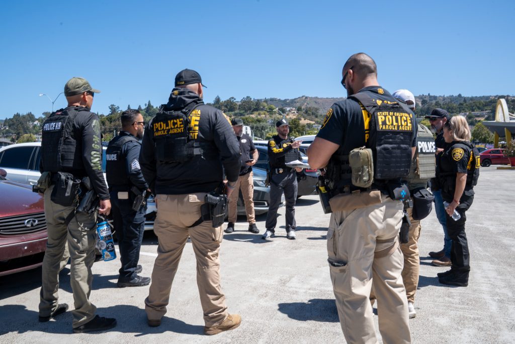 Parole agents are briefed on the operation in Oakland, California.