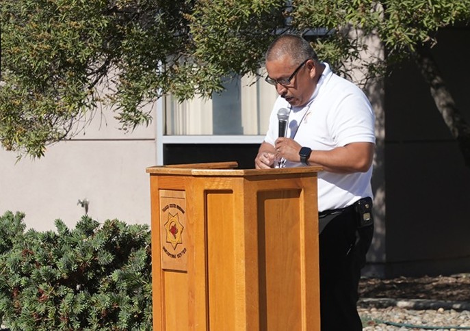 Lectern with a man speaking into a microphone at WSP-RC.