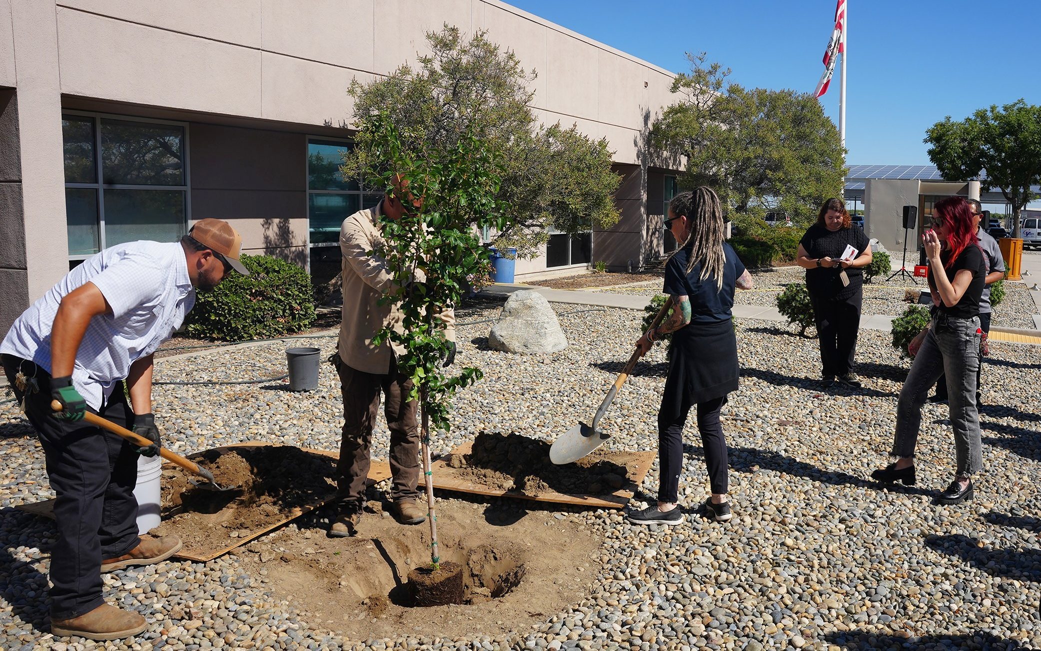 Staff from Wasco State Prison-Reception Center plant a tree in honor of Juan Carlos Garcia Espinoza, a licensed clinical social worker who passed away.
