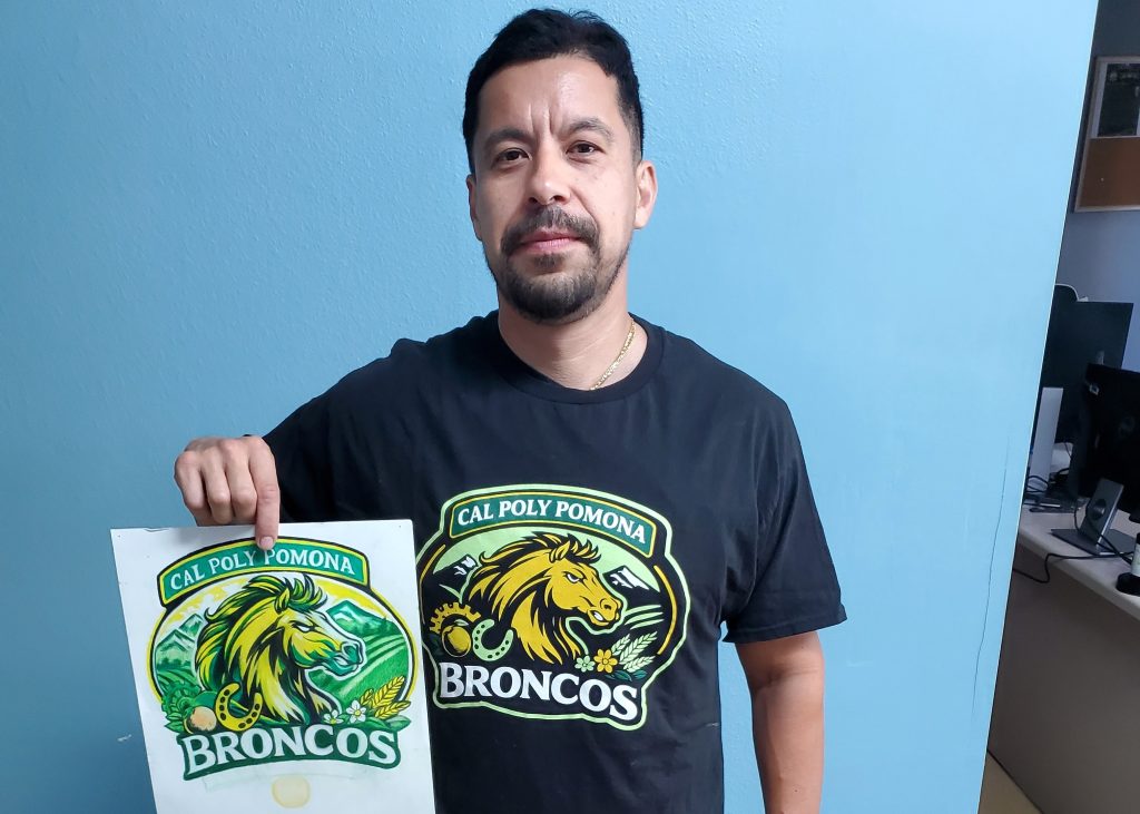 Angel Paredes poses with winning design artwork